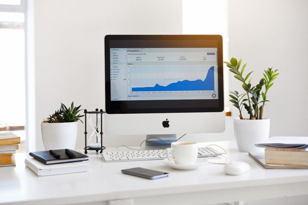 Modern workspace with a desktop computer displaying analytics, symbolising professional website design services in Melbourne focused on growth and performance.